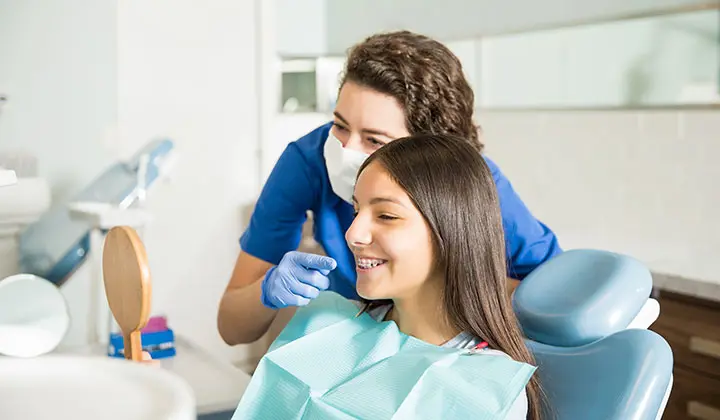 Girl with braces at the dentist