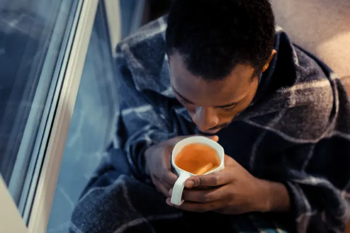 Man Drinking Tea With Diarrhoea Disease